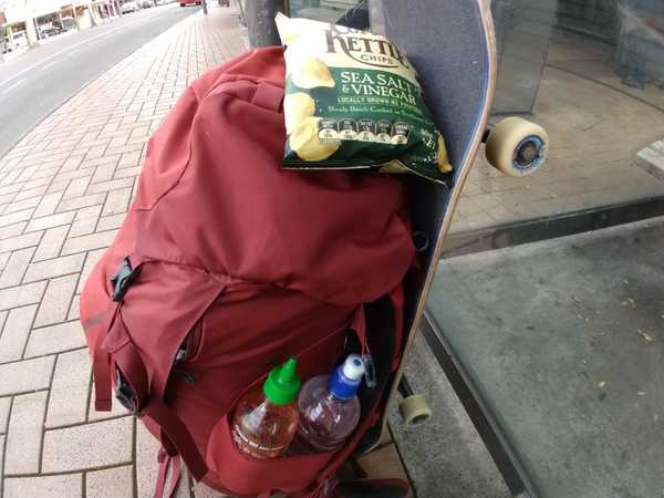 Essentials for backpacking: sea salt and vinegar chips, sriracha, water, and a set of wheels.